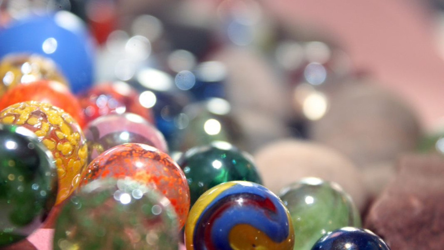 Colourful marbles are arranged on a table