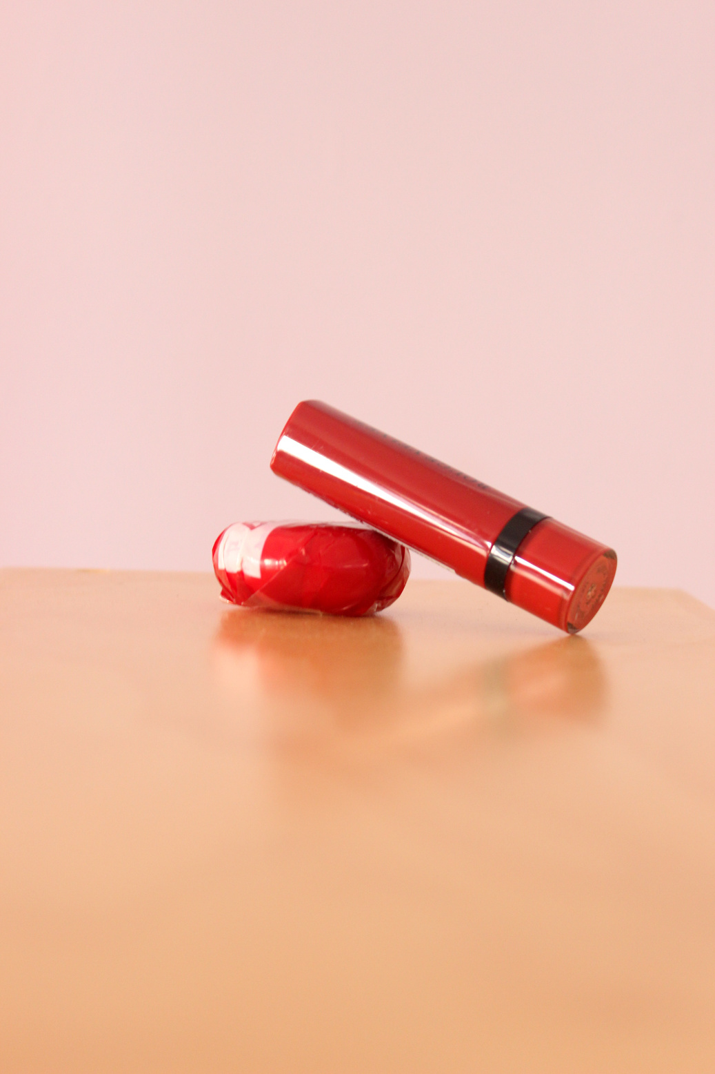 Lipstick on a table propped up by babel.